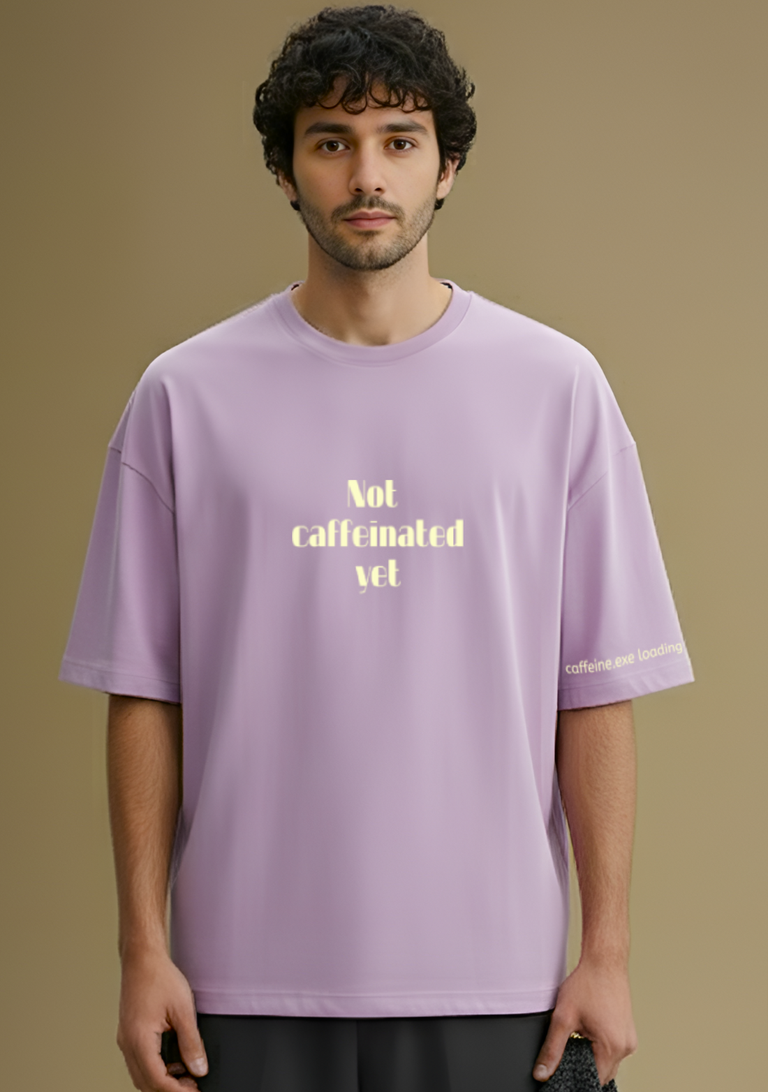 Person wearing a light purple t-shirt with yellow text on a brown background